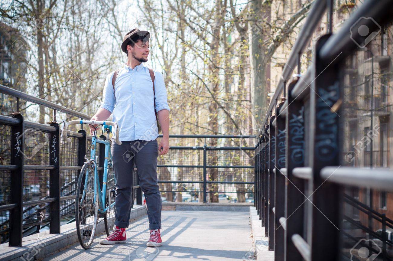 19662271-hipster-young-man-on-bike-in-the-city-Stock-Photo-fashion.jpg