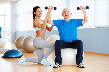 33695987-weight-exercises-confident-female-physical-therapist-working-with-senior-man-in-health-club.jpg